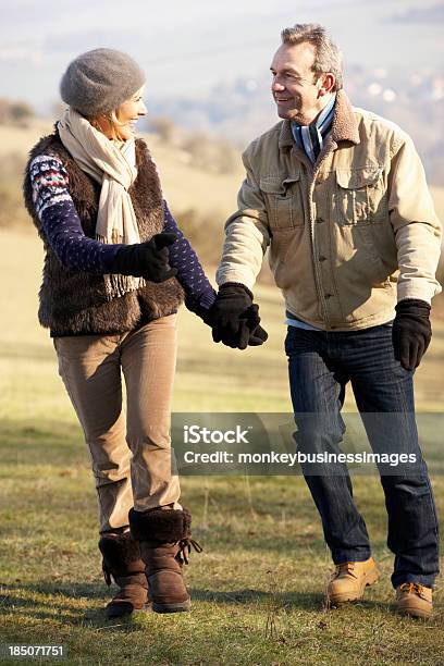 Mature Couple On Country Walk In Winter Stock Photo - Download Image Now - 60-69 Years, Active Lifestyle, Active Seniors