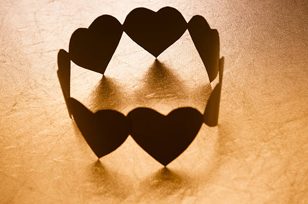 Heart shape paper dolls in circle for teamwork