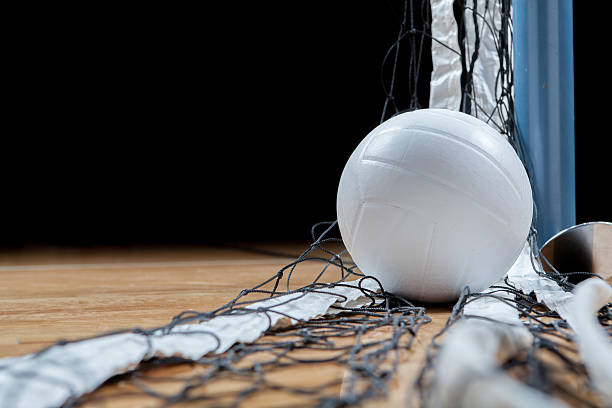 Volleyball A white volleyball on the floor in a darkened gym.See my sports court photos stock pictures, royalty-free photos & images