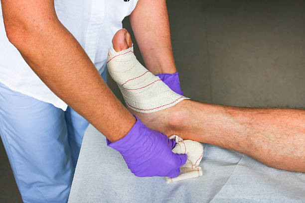 istock Nurse is changing bandage to  patient with wound 185072258