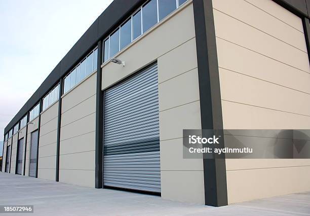 A Wooden Warehouse Building Lit Up By The Sun Stock Photo - Download Image Now - Rolling Garage Door, Warehouse, Building Exterior