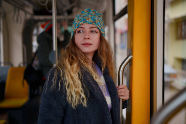 istock Young woman standing in tramway 1850729486