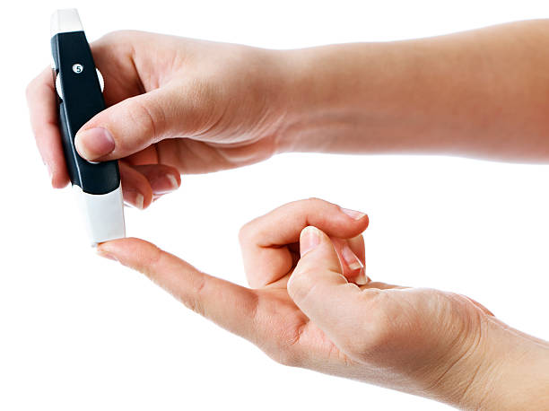 Cтоковое фото Диабетическая введении пальцев, определение уровня сахара в крови