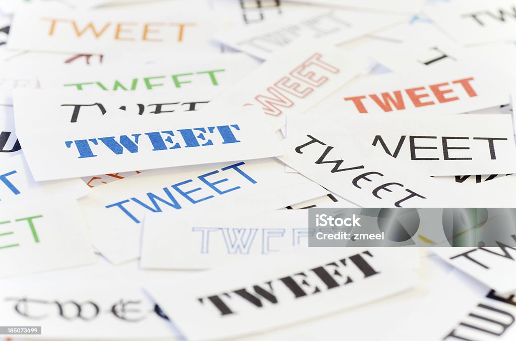 Tweets Little papers with the word TWEET in many different letter types and colors Brand Name Online Messaging Platform Stock Photo