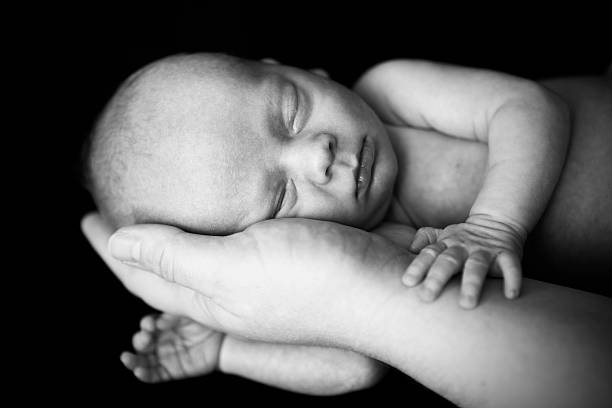 istock Newborn Sleeping in Mother's Hand 185073645