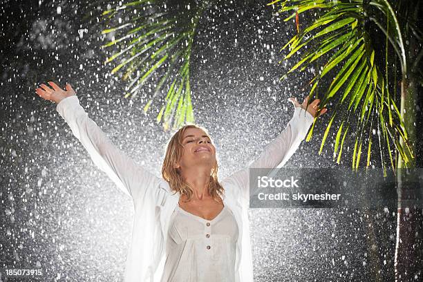 Happy Woman Praying During Tropical Rain Stock Photo - Download Image Now - Adult, Adults Only, Arms Outstretched