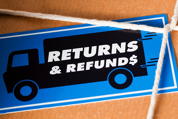 Return and Refund Package US Dollar Return the goods by a courier for a Dollar Refund. Close up of a brown paper parcel, tied with string and a Return & Refunds sticker. travel refund stock pictures, royalty-free photos & images