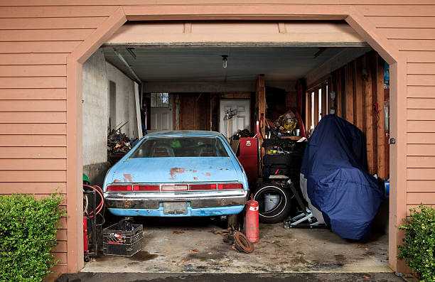 istock Small garage filled with a car, motorcycle and tools 185074451