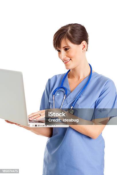 Female Nurse Doctor Working On Laptop With White Background Stock Photo - Download Image Now