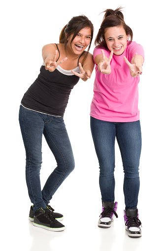 Two excited happy teenage girls give peace signs. http://s3.amazonaws.com/drbimages/m/dr.jpg
