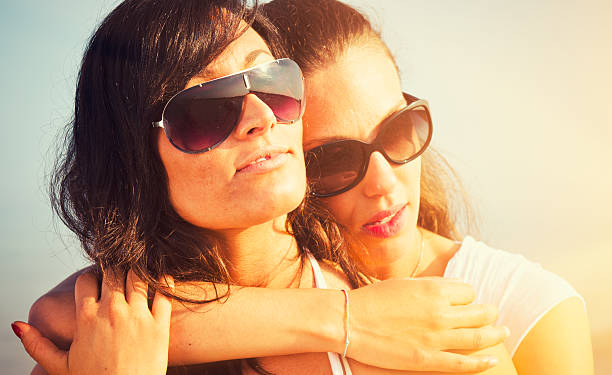 istock Lesbian couple relax embracing at sea 185075430