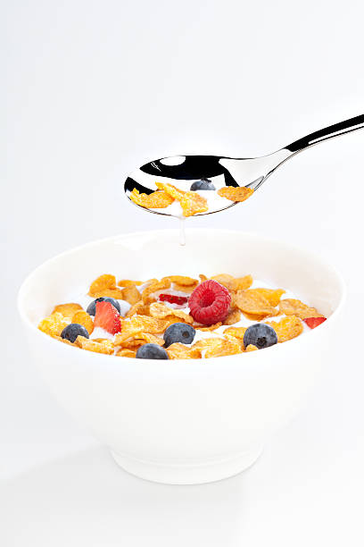 istock eating cornflakes with milk and berries 185075474