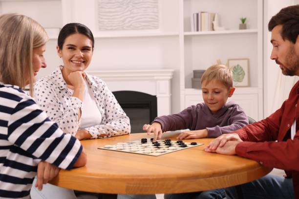 istock Family playing checkers at coffee table in room 1850759721