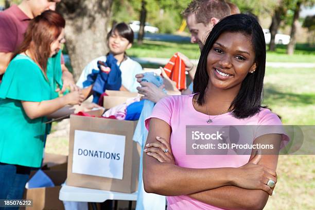 Confident Woman At An Outdoor Donation Center Stock Photo - Download Image Now - A Helping Hand, Adult, Adults Only