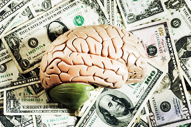 istock The thinking man's guide to making money: brain on dollars 185076309