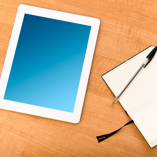 istock blank digital tablet and agenda on the table 185076369