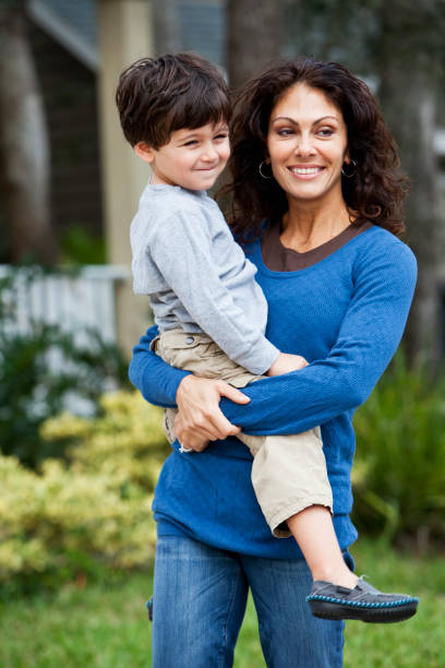 istock Little boy with mother in front of house 185076749