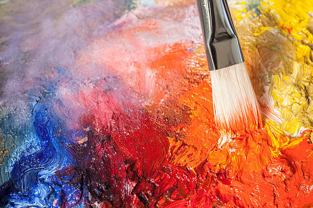 istock Paintbrush with red oil paint on a classical palette 185076956