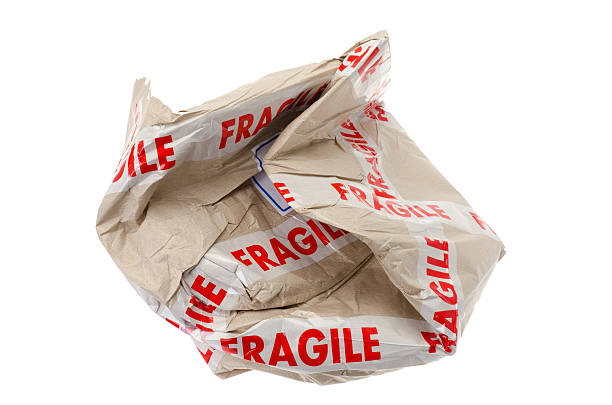 istock Crushed cardboard box with a fragile warning label 185077412
