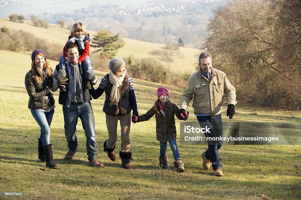 3 generations of family taking winter country walk together 3 Generation family on country walk in winter holding hands Winter Stock Photo