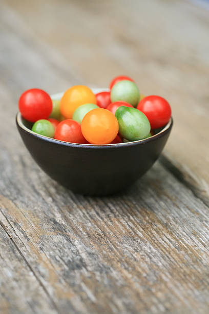 istock Small bowl with fresh harvested various cherry tomatoes 185077692