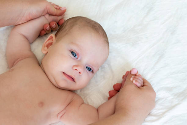 istock Father's loving hands massage his little infant. 1850779062