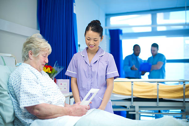patient talks to nurse patient shows nurse get well soon cards hospital card stock pictures, royalty-free photos & images
