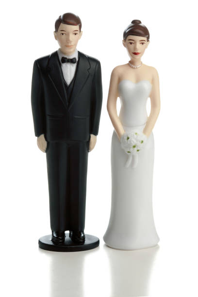 istock Wedding cake bride and groom statuettes on white 185078097
