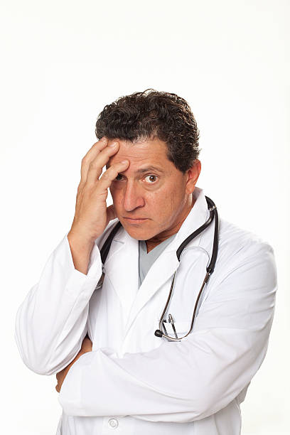 istock A stressed and worried doctor against a white background 185078491