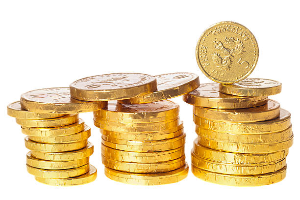 istock Chocolate money coins stacked on white 185078649