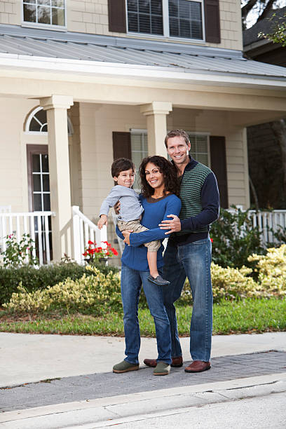 istock Family standing in front of house 185078726