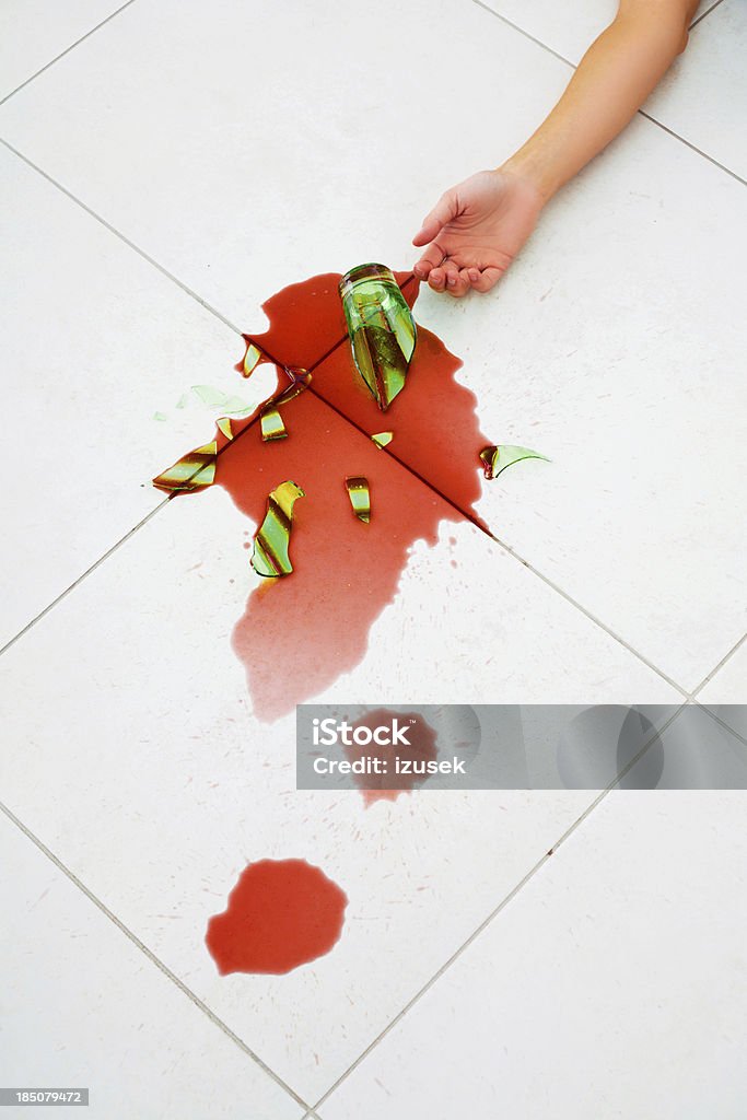 Broken glass of juice Close-up on woman's hand and broken glass of juice. Adult Stock Photo