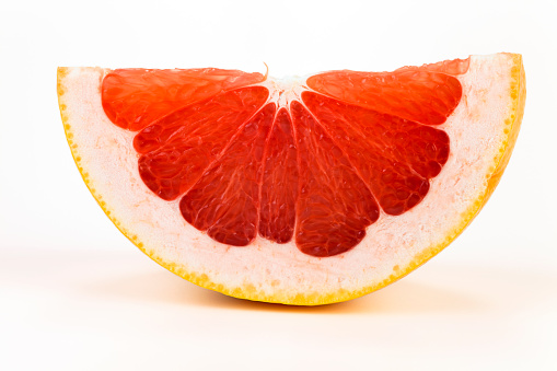background made with a heap of sliced grapefruits