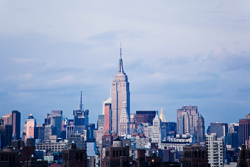 A variety of modern office buildings and skyscrapers with a blue sky in the Lower Manhattan New York City skyline