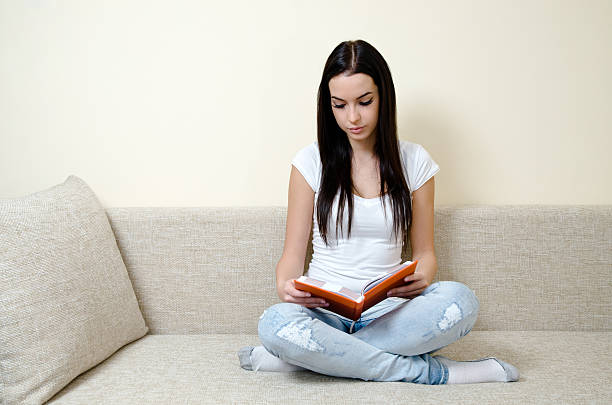 istock teen girl reading 185080073