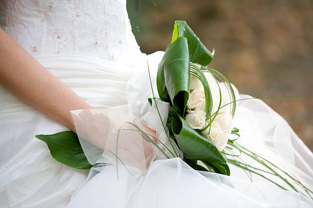 istock Bride in white carrying a bouquet 185080297