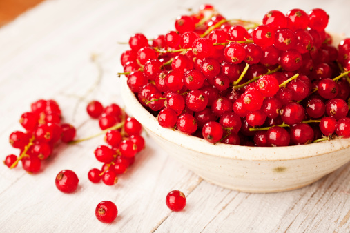 red currant berries in a bowl, covered with drops of water