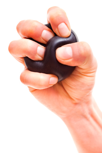 Close-up of hand squeezing a stress ball.
