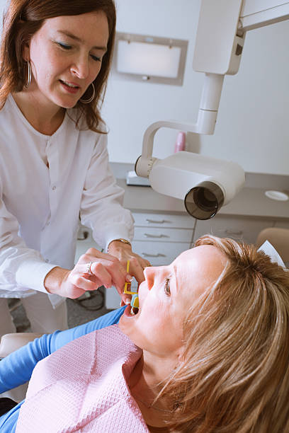 istock Dental Professional Preparing X-Ray for a Patient in Office Vertical 185081670