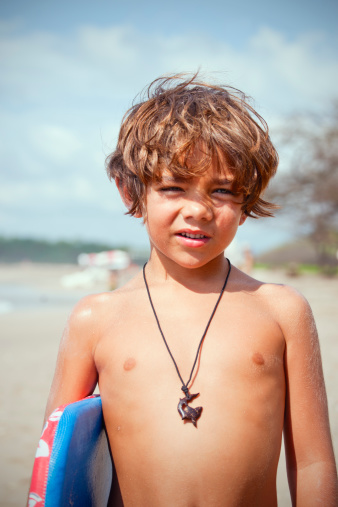 A retro snapshot-styled portrait of a 6 year-old boy on a beach.For more beach related images please click: