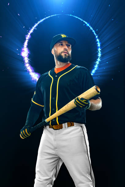 istock Baseball player with bat on dark background. Ballplayer portrait. 1850824153