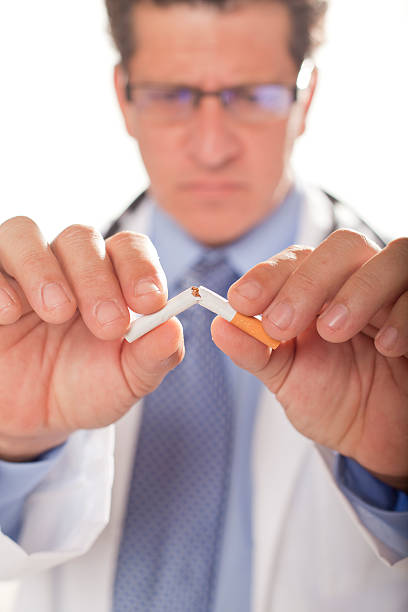 Doctor Breaking Cigarette stock photo