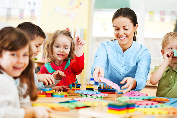 istock Nursery teacher playing with the kids. 185082766