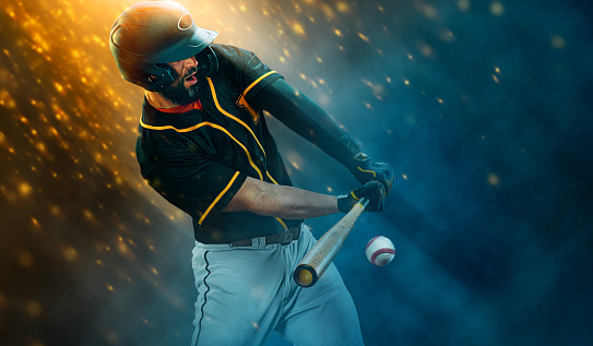 Porfessional baseball player with bat taking a swing on grand arena. Ballplayer on stadium in action