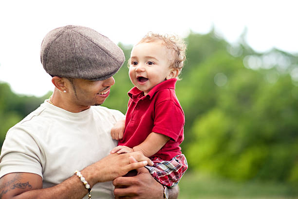 istock Young Father Holding His Happy Son, in Outdoor Setting 185083726