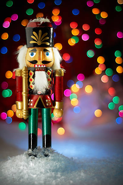 Nutcracker in Snow with Lights Nutcracker in snow with christmas tree lights background nutcracker photos stock pictures, royalty-free photos & images