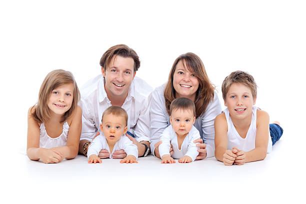 smiling parents with kids and baby twins isolated on white