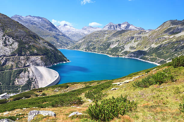 View of mountain lake and highway in autumn. Koelnbreinspeicher Gamskarnock, Carinthia, Austria Europe