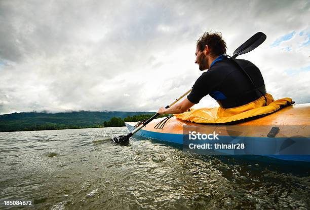 Man Paddling In Wooden Kayak Stock Photo - Download Image Now - Activity, Adult, Adults Only