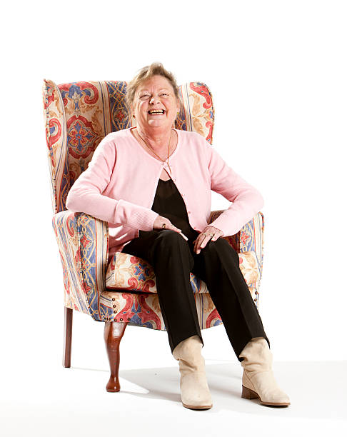 istock seniors: happy smiling pensioner in armchair 185084932